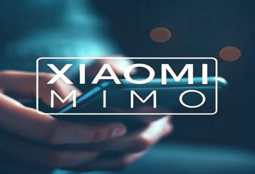 A hand holding a smartphone with text displaying the name of the Xiaomi MiMo AI model.